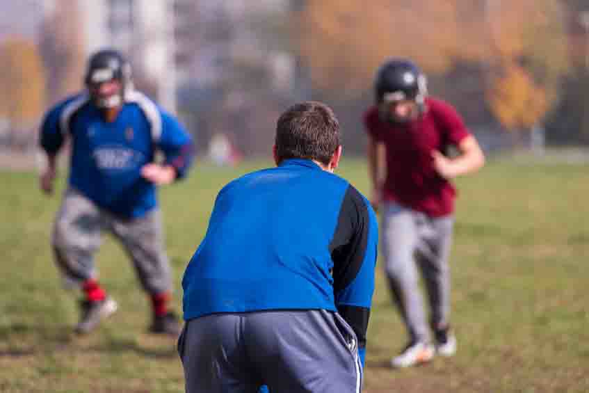 american football team with coach in action